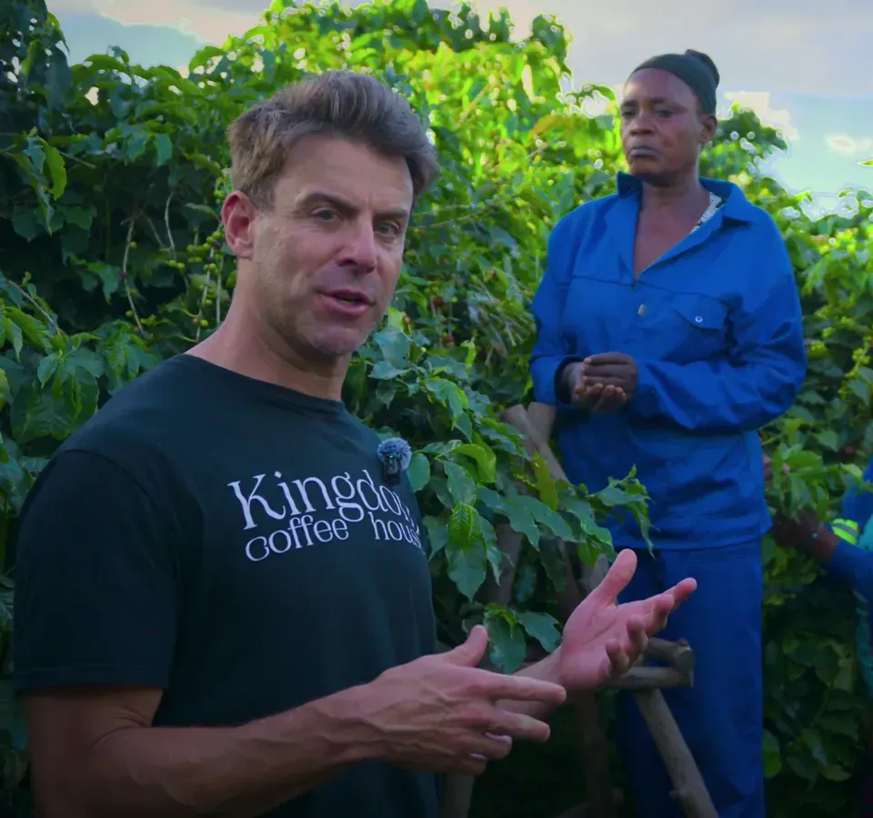 Daniel Crenshaw talking with coffee pickers during harvest at a partner farm