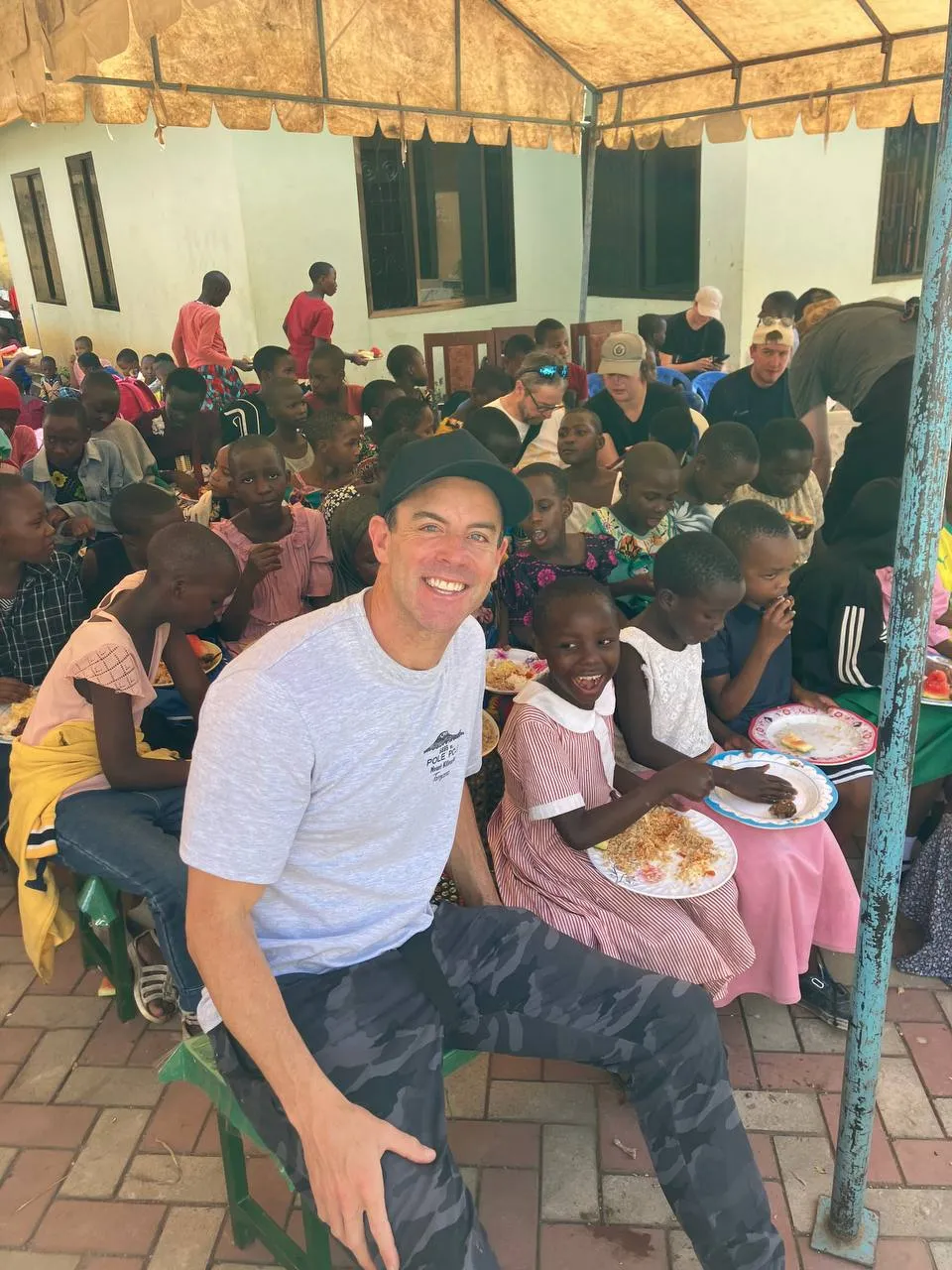 Daniel Crenshaw sharing a meal with children during a ministry visit